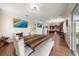 Open dining space adjacent to kitchen area with a large table, modern lighting, and hardwood floors at 5522 Cartagena Dr, Sarasota, FL 34233