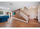 Open foyer area showcases wood floors, staircase, decorative wall accents, and natural light at 5522 Cartagena Dr, Sarasota, FL 34233