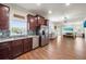 Open-concept kitchen with stainless steel appliances and wood cabinets, flowing into the dining area at 5522 Cartagena Dr, Sarasota, FL 34233