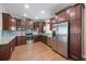 Spacious kitchen features stainless steel appliances, wood cabinets, granite countertops, and tile backsplash at 5522 Cartagena Dr, Sarasota, FL 34233