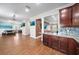 View of the open-concept floor plan showcasing kitchen, dining, and living spaces with continuous flooring at 5522 Cartagena Dr, Sarasota, FL 34233