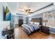 This main bedroom features blue walls, trey ceilings, and wood floors at 5522 Cartagena Dr, Sarasota, FL 34233