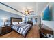 This spacious main bedroom features a trey ceiling, wood floors, and blue walls at 5522 Cartagena Dr, Sarasota, FL 34233
