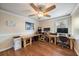 This spacious home office features wood floors, a ceiling fan, and multiple desks at 5522 Cartagena Dr, Sarasota, FL 34233