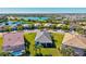Aerial view of a neighborhood with lake views and luxurious properties with lush lawns at 5590 Rain Lily Ct, Sarasota, FL 34238