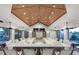 Community bar area featuring a long counter with seating and views of the surrounding amenities at 5590 Rain Lily Ct, Sarasota, FL 34238