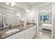 Bathroom showcases dual sinks with granite countertops, walk-in shower, and opens to the bedroom at 5590 Rain Lily Ct, Sarasota, FL 34238