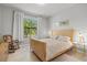 Neutral bedroom with a large window providing lots of natural light and views of greenery at 5590 Rain Lily Ct, Sarasota, FL 34238