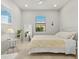 Bright bedroom featuring neutral walls, natural light, and ceiling fan at 5590 Rain Lily Ct, Sarasota, FL 34238