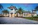 Elegant clubhouse exterior featuring lush landscaping, modern architecture, and welcoming entryway at 5590 Rain Lily Ct, Sarasota, FL 34238