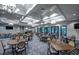 Spacious clubhouse with ample seating arrangements and elegant chandeliers at 5590 Rain Lily Ct, Sarasota, FL 34238
