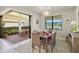 Elegant dining area with view and sliding doors to outdoor dining at 5590 Rain Lily Ct, Sarasota, FL 34238