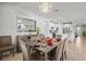 Open concept dining area next to the kitchen features a large mirror and chandelier at 5590 Rain Lily Ct, Sarasota, FL 34238