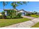 Well-maintained single-story home with lush landscaping, and a brick driveway at 5590 Rain Lily Ct, Sarasota, FL 34238