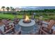 Outdoor fire pit area with comfortable seating, perfect for gatherings and relaxation at 5590 Rain Lily Ct, Sarasota, FL 34238