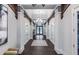 Grand hallway with stylish tile flooring and intricate ceiling details at 5590 Rain Lily Ct, Sarasota, FL 34238