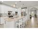 Spacious kitchen island with seating, complemented by stainless steel appliances and modern fixtures at 5590 Rain Lily Ct, Sarasota, FL 34238