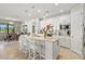 Well-appointed kitchen with a center island, white cabinets, granite countertops, and stainless steel appliances at 5590 Rain Lily Ct, Sarasota, FL 34238