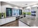 Modern kitchen with stainless steel appliances, open counter seating area, and views of the outdoor community space at 5590 Rain Lily Ct, Sarasota, FL 34238