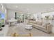 Spacious living room with open floor plan to kitchen and dining area at 5590 Rain Lily Ct, Sarasota, FL 34238
