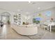 Bright living room with tiled floor, modern furnishings, and built in bookcase at 5590 Rain Lily Ct, Sarasota, FL 34238