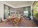 Outdoor patio with dining set leads into an open-concept kitchen, dining, and living area at 5590 Rain Lily Ct, Sarasota, FL 34238