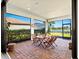 The brick patio offers a tranquil view of the lake, a dining set, and a beautiful outdoor space at 5590 Rain Lily Ct, Sarasota, FL 34238