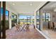 This screened patio features views of the lake, with an outdoor dining area and indoor/outdoor living at 5590 Rain Lily Ct, Sarasota, FL 34238