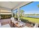 A screened patio offers an outdoor seating area, with lake views and a tranquil outdoor living space at 5590 Rain Lily Ct, Sarasota, FL 34238