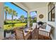 This covered patio with a view includes lounge seating and provides ample space for entertaining at 5590 Rain Lily Ct, Sarasota, FL 34238