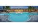 Stunning community pool featuring ample seating, palm trees, and resort-style amenities at 5590 Rain Lily Ct, Sarasota, FL 34238