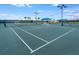 Brightly lit community tennis courts with pristine blue and green playing surface at 5590 Rain Lily Ct, Sarasota, FL 34238