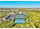 Aerial view of community tennis and pickleball courts, surrounded by lush landscaping and neighborhood homes at 5590 Rain Lily Ct, Sarasota, FL 34238