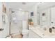 Bathroom featuring a glass-enclosed shower, tiled walls, handheld shower fixture, and a white sink at 5647 Sheffield Greene Cir # 29, Sarasota, FL 34235