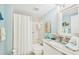 Cozy bathroom featuring a bathtub with shower, a single sink, and beach-themed decor at 5647 Sheffield Greene Cir # 29, Sarasota, FL 34235