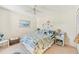 Bedroom with coastal decor, ceiling fan, beach-themed art, and a cozy atmosphere at 5647 Sheffield Greene Cir # 29, Sarasota, FL 34235