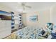 Inviting bedroom with coastal-themed decor, TV, white dresser, and beach artwork at 5647 Sheffield Greene Cir # 29, Sarasota, FL 34235