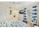 Bedroom showcasing coastal decor, TV, ample storage, and a view from the window at 5647 Sheffield Greene Cir # 29, Sarasota, FL 34235