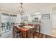 Dining area with a wooden table, chandelier, and sliding glass doors to the patio at 5647 Sheffield Greene Cir # 29, Sarasota, FL 34235