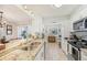 Bright kitchen with granite countertops, stainless steel appliances, and a breakfast bar at 5647 Sheffield Greene Cir # 29, Sarasota, FL 34235