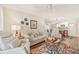 Spacious living room with a ceiling fan, lamps, and stylish coastal-themed decor at 5647 Sheffield Greene Cir # 29, Sarasota, FL 34235