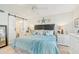 Charming main bedroom with sliding barn door access to en suite bathroom, coastal decor, and ceiling fan at 5647 Sheffield Greene Cir # 29, Sarasota, FL 34235