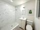 Beautiful bathroom featuring a tiled shower, modern vanity, and stylish decor for a spa-like experience at 568 Sheridan Dr, Venice, FL 34293