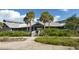 Attractive building exterior with a modern design, surrounded by palm trees and lush greenery, creating a welcoming atmosphere at 568 Sheridan Dr, Venice, FL 34293