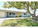 Inviting single-story home with a bright yellow front door and a meticulously kept lawn at 568 Sheridan Dr, Venice, FL 34293