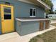 The exterior showcases a painted home and features a convenient shed with weathered doors at 568 Sheridan Dr, Venice, FL 34293