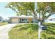 Charming single-story home with a well-maintained lawn and a vibrant yellow front door at 568 Sheridan Dr, Venice, FL 34293
