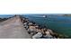 Scenic view of the jetty with rocks, water, and a boat passing by, capturing the beauty of the coastal landscape at 568 Sheridan Dr, Venice, FL 34293