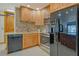 Kitchen featuring wood cabinets, granite countertops, stainless steel appliances, and modern tile backsplash at 568 Sheridan Dr, Venice, FL 34293