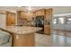 Well-appointed kitchen with wood cabinetry, tile backsplash, and modern appliances at 568 Sheridan Dr, Venice, FL 34293